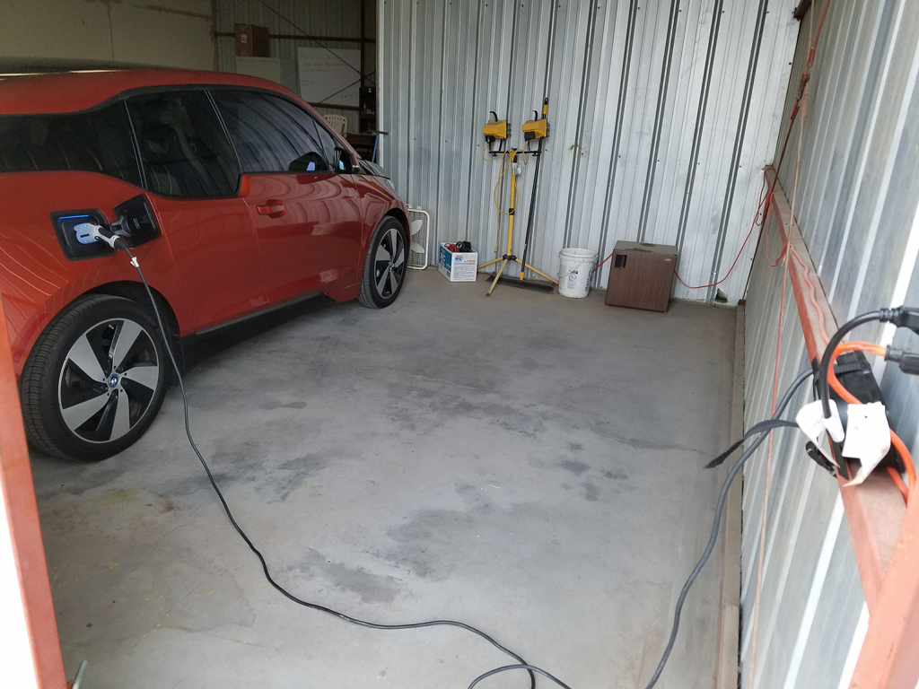 My i3, plugged in to trickle-charge in the hangar for the trip
